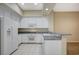 White kitchen with granite counters, stainless steel appliances, and tile flooring at 20 Serene Ave # 201, Las Vegas, NV 89123