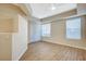 Bright living room with wood flooring, a ceiling fan, and multiple windows at 20 Serene Ave # 201, Las Vegas, NV 89123