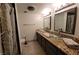 Bathroom featuring dual vessel sinks, granite countertop, and custom tiled shower at 205 E Harmon Ave # 704, Las Vegas, NV 89169