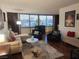Comfortable living room featuring city views, a cozy sofa, and stylish furnishings at 205 E Harmon Ave # 704, Las Vegas, NV 89169