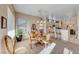 Comfortable dining area featuring a chandelier, natural light, and views into the kitchen at 2069 King Mesa Dr, Henderson, NV 89012