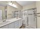 Bathroom featuring a double sink vanity, a large mirror, and glass shower door at 2119 Lewiston Pl, Henderson, NV 89044