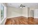 Spacious bedroom featuring a ceiling fan and hardwood floors, illuminated by natural light from the windows at 2119 Lewiston Pl, Henderson, NV 89044