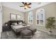 Comfortable bedroom with modern decor, natural light, and arched windows at 2119 Lewiston Pl, Henderson, NV 89044