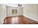 Bright bedroom with hardwood floors, fan, and natural light filtering in through a window at 2119 Lewiston Pl, Henderson, NV 89044