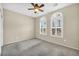 Carpeted bedroom featuring dual arched windows and a modern ceiling fan at 2119 Lewiston Pl, Henderson, NV 89044