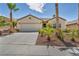 Charming single-story home featuring desert landscaping, a two-car garage, and a neutral color palette at 2119 Lewiston Pl, Henderson, NV 89044