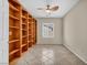 Home office features a full wall of built-in shelving and a ceiling fan at 2119 Lewiston Pl, Henderson, NV 89044