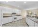 Bright kitchen features white cabinets, neutral countertops, tile flooring, and modern appliances at 2119 Lewiston Pl, Henderson, NV 89044