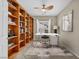 Home office with built-in bookshelves, a modern desk setup, and neutral color scheme at 2119 Lewiston Pl, Henderson, NV 89044