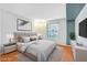 Staged bedroom with hardwood floors, a gray accent wall, and a large window at 2300 E Silverado Ranch Blvd # 1119, Las Vegas, NV 89183