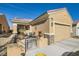 Charming one-story tan home with a front porch, a two-car garage and stone accents at 2816 Ground Robin Dr, North Las Vegas, NV 89084