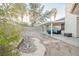 Spacious backyard featuring a covered patio and stone walking path at 2823 Landau Ct, Henderson, NV 89074