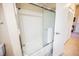 White shower and bathtub combination with sliding glass door and tile flooring at 2823 Landau Ct, Henderson, NV 89074