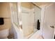 This bathroom includes a shower over tub combo with sliding glass doors, neutral wall colors, and tile flooring at 2823 Landau Ct, Henderson, NV 89074