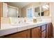 Bathroom featuring double sinks, tiled countertops, natural light, and ample counter space at 2823 Landau Ct, Henderson, NV 89074