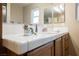 Bathroom vanity featuring a sink, white countertops, cabinets, and a well-lit mirror at 2823 Landau Ct, Henderson, NV 89074