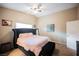 Bedroom showcasing natural light, neutral tones, and a stylish, dark tufted king-size bed at 2823 Landau Ct, Henderson, NV 89074