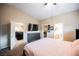 Spacious bedroom featuring an ensuite bathroom, closet, and a view into the living and kitchen area at 2823 Landau Ct, Henderson, NV 89074
