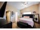 This main bedroom features a vaulted ceiling, a dark tufted headboard, and generous closet space at 2823 Landau Ct, Henderson, NV 89074
