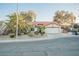 Charming house featuring low-maintenance desert landscaping, a tile roof, and an attached garage at 2823 Landau Ct, Henderson, NV 89074