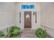 Charming front entrance with decorative door, sidelights, and manicured landscaping at 2823 Landau Ct, Henderson, NV 89074