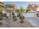 Attractive front yard with desert landscaping, a mature palm tree, and a well-kept lawn at 2823 Landau Ct, Henderson, NV 89074