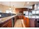 Gourmet kitchen featuring stainless steel appliances, granite counters, and custom wood cabinetry with a wine rack at 2823 Landau Ct, Henderson, NV 89074