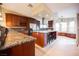 Spacious kitchen with granite countertops, stainless steel appliances, and a central island with bar seating at 2823 Landau Ct, Henderson, NV 89074