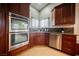 Gourmet kitchen with stainless steel appliances, double ovens, and a corner sink with natural light at 2823 Landau Ct, Henderson, NV 89074