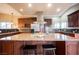 Open kitchen featuring a large island with granite countertop, seating, and stainless steel appliances at 2823 Landau Ct, Henderson, NV 89074