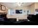 Bright living space with brick fireplace and a large TV at 2823 Landau Ct, Henderson, NV 89074