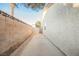 Narrow side yard featuring a concrete walkway and a block wall for enhanced privacy at 2823 Landau Ct, Henderson, NV 89074