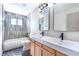 Bright bathroom with double sinks, modern fixtures, and stylish black-and-white patterned flooring at 3119 Desmond Ave, Las Vegas, NV 89121