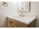 Bathroom with a wood-grain vanity, white countertop, and modern faucet at 3263 Gold Run St, North Las Vegas, NV 89032