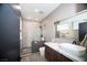 Modern bathroom featuring an open shower, dark wood cabinet and a white marble countertop at 3530 S Spring Mountain Blvd Ct, Pahrump, NV 89048