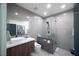 Modern bathroom featuring a glass shower, stylish gray tile, and a vessel sink on a wood vanity at 3530 S Spring Mountain Blvd Ct, Pahrump, NV 89048