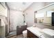 Modern bathroom featuring an open shower, dark wood cabinet and a marble countertop and backsplash at 3530 S Spring Mountain Blvd Ct, Pahrump, NV 89048