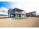 Modern two-story home featuring sleek architectural lines and a spacious gravel yard at 3530 S Spring Mountain Blvd Ct, Pahrump, NV 89048
