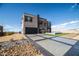 Modern home with a spacious driveway and desert landscaping at 3530 S Spring Mountain Blvd Ct, Pahrump, NV 89048