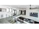 Hallway overlooking kitchen and living area, featuring glass railings and ample lighting at 3530 S Spring Mountain Blvd Ct, Pahrump, NV 89048