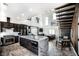 Stylish kitchen with stainless steel appliances, marble counters, and adjoining living area at 3530 S Spring Mountain Blvd Ct, Pahrump, NV 89048