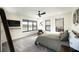 The main bedroom features generous windows for natural light, a ceiling fan, and plush carpeting for added comfort at 3530 S Spring Mountain Blvd Ct, Pahrump, NV 89048