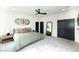 The main bedroom features generous windows for natural light, a ceiling fan, and plush carpeting for added comfort at 3530 S Spring Mountain Blvd Ct, Pahrump, NV 89048