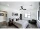 Bright bedroom featuring a ceiling fan, a modern light fixture and a large window with desert views at 3530 S Spring Mountain Blvd Ct, Pahrump, NV 89048