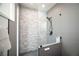 Modern shower with decorative tile and a glass surround, alongside a partial wall for added privacy at 3530 S Spring Mountain Blvd Ct, Pahrump, NV 89048