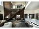 Open concept living space showcasing wood staircase and modern design elements at 3530 S Spring Mountain Blvd Ct, Pahrump, NV 89048