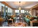 Bright living room with two green sofas, a modern chandelier and a dining room with great Las Vegas views at 360 E Desert Inn Rd # 407, Las Vegas, NV 89109