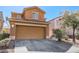 Charming home featuring a two-car garage, desert landscaping, and a spacious driveway at 4130 Neighborly Ct, North Las Vegas, NV 89032