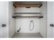 A utilitarian laundry room with shelving and white plank flooring at 4130 Neighborly Ct, North Las Vegas, NV 89032